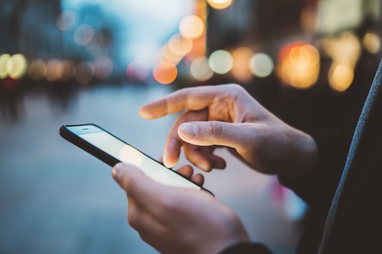 Hand holding a phone - Copy