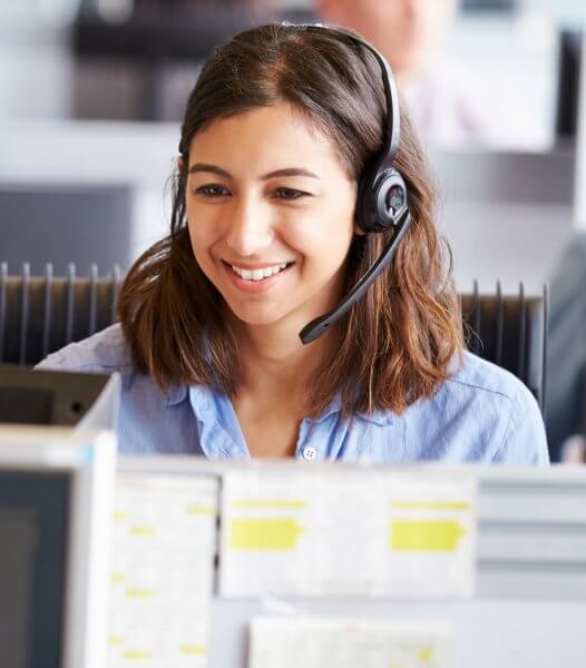 collections solutions - woman with phone headset looking at computer