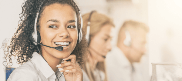 Woman on phone at call center answering the question, How does DirectDrop Voicemail work?