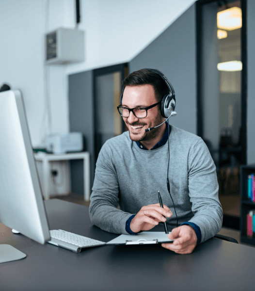 Man at work on phone headset - How does DirectDrop Voicemail work