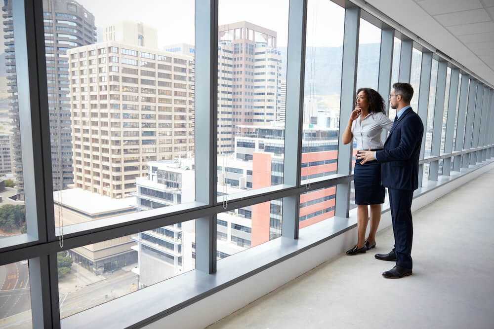 commercial real estate business employees staring out the window